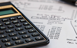 Calculator and pen on finances