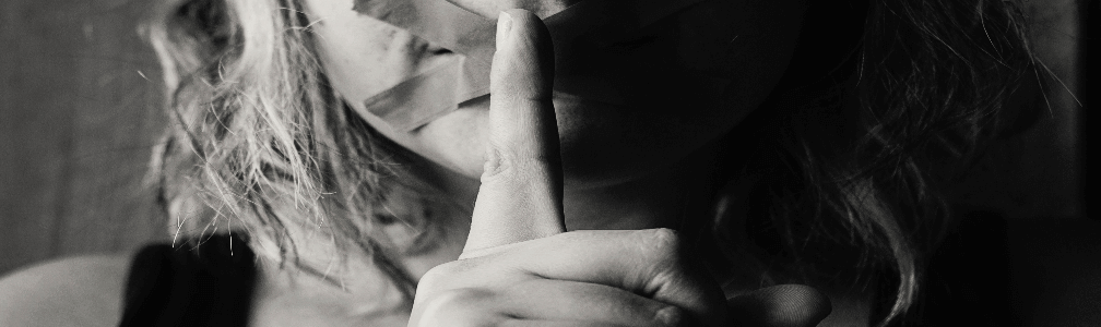 woman hushing with finger to lips