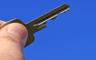 Hand holding key in air