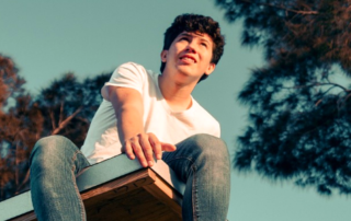 Young man sitting on roof