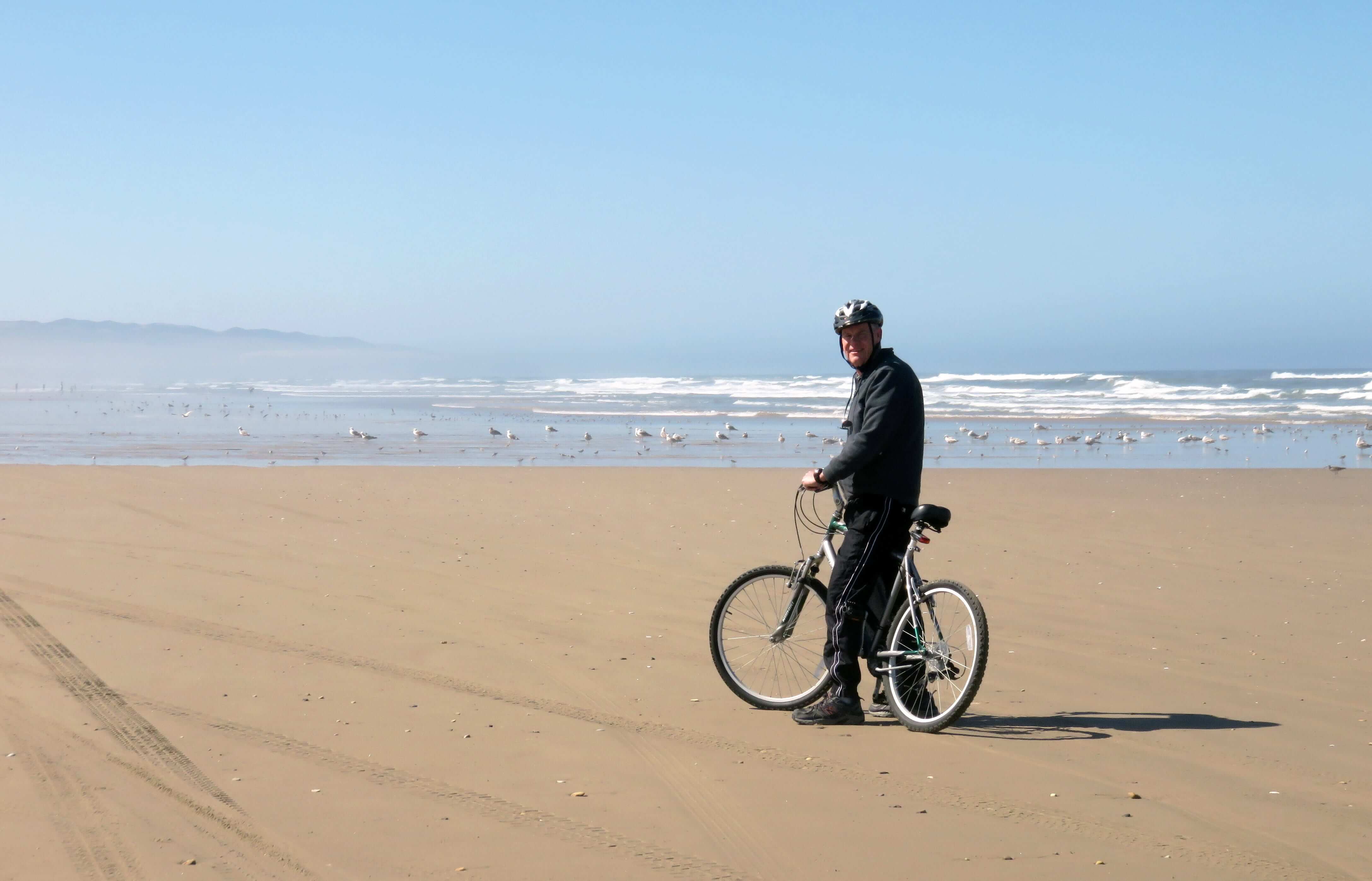 man cycling on beach